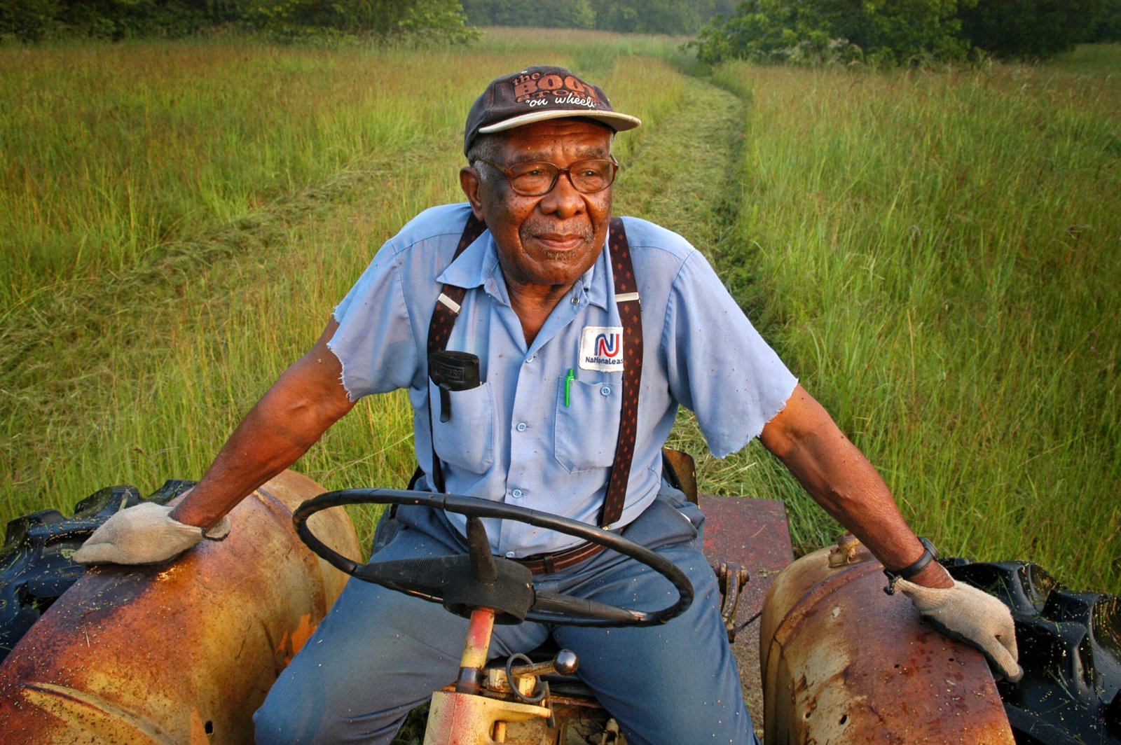 Eddie Cotton, 82, Hermanville, MS,  clears a field for a fall crop of hay, using a 40-yr-old tractor. He is among thousands of black farmers denied federal loans in past years. 
"They took away my ability to provide  for my family," he says of the discrimination.

©Robin Nelson/ZUMA